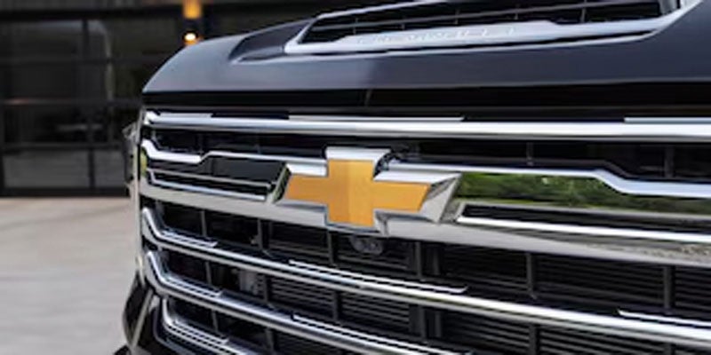 The front grille emblem of the 2026 Chevrolet Silverado 2500 HD in Benton, AR